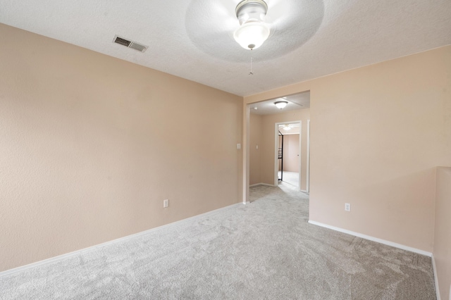 101 Colinas Ave NE, Albuquerque, NM 87113 - carpeted spare room with baseboards, visible vents, and a textured ceiling