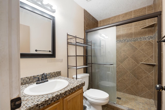 101 Colinas Ave NE, Albuquerque, NM 87113 - bathroom featuring a shower stall, toilet, vanity, a textured wall, and a textured ceiling