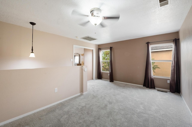 101 Colinas Ave NE, Albuquerque, NM 87113 - carpeted empty room featuring baseboards, visible vents, a textured ceiling, and a ceiling fan