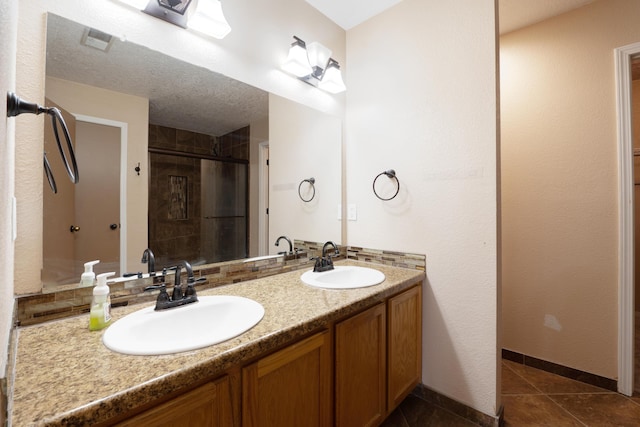 101 Colinas Ave NE, Albuquerque, NM 87113 - bathroom with tile patterned flooring, a stall shower, double vanity, and a sink