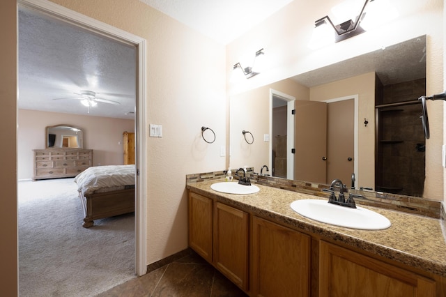 101 Colinas Ave NE, Albuquerque, NM 87113 - bathroom featuring a sink, a textured ceiling, ensuite bath, and a ceiling fan