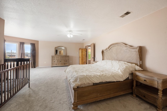 101 Colinas Ave NE, Albuquerque, NM 87113 - bedroom with visible vents, carpet flooring, a textured ceiling, and a ceiling fan
