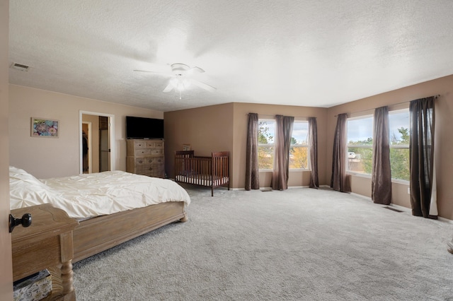 101 Colinas Ave NE, Albuquerque, NM 87113 - bedroom with a ceiling fan, visible vents, carpet floors, and a textured ceiling