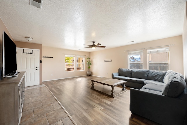101 Colinas Ave NE, Albuquerque, NM 87113 - living area featuring visible vents, a textured ceiling, a ceiling fan, and wood finished floors