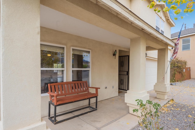 101 Colinas Ave NE, Albuquerque, NM 87113 - doorway to property featuring stucco siding and a garage