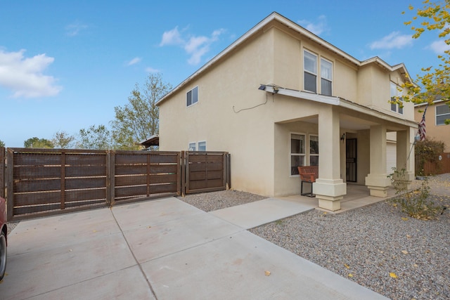 101 Colinas Ave NE, Albuquerque, NM 87113 - view of side of home featuring a gate, stucco siding, and fence