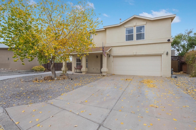 101 Colinas Ave NE, Albuquerque, NM 87113 - traditional home featuring stucco siding, a porch, fence, concrete driveway, and an attached garage