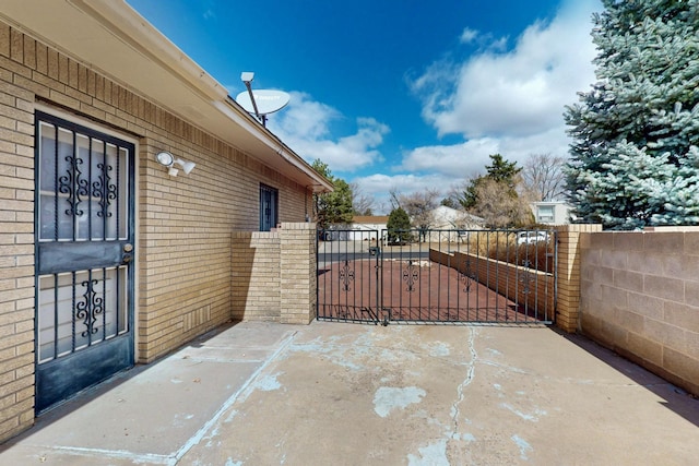 view of patio with fence and a gate