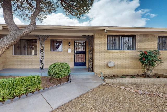 property entrance with brick siding