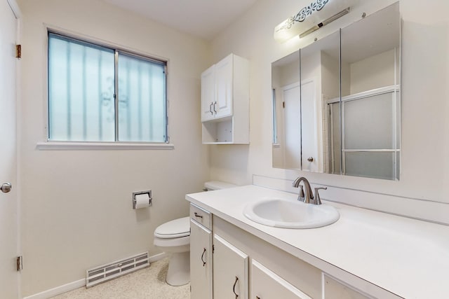 bathroom featuring vanity, baseboards, visible vents, an enclosed shower, and toilet