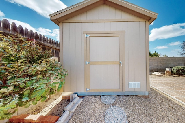 view of shed with a fenced backyard