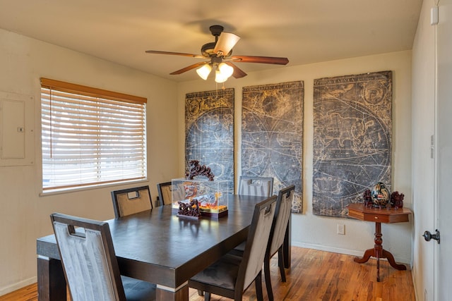 dining room featuring baseboards, wood finished floors, and ceiling fan