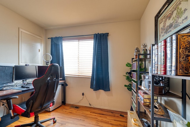 home office with wood finished floors and baseboards