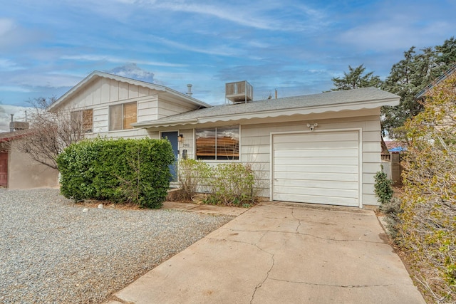 tri-level home featuring concrete driveway and an attached garage