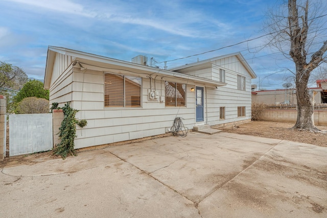 view of front of house featuring a patio area and fence