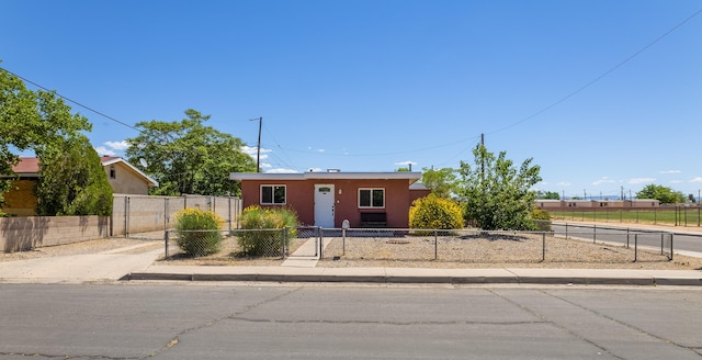 view of front of house with a fenced front yard and stucco siding