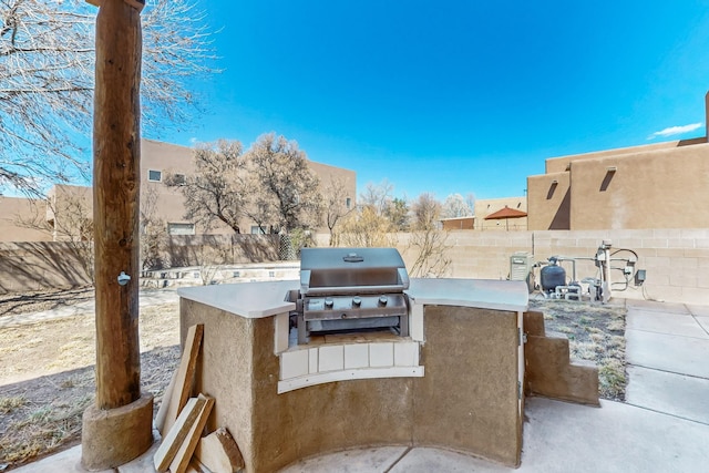 1001 Calle Garza NE, Albuquerque, NM 87113 - view of patio featuring area for grilling and a fenced backyard