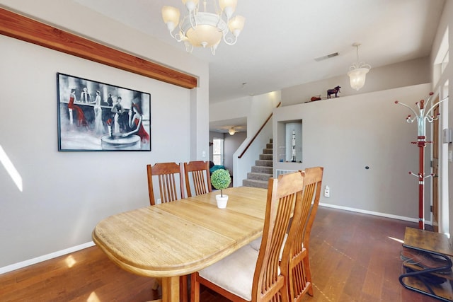 1001 Calle Garza NE, Albuquerque, NM 87113 - dining room featuring visible vents, wood finished floors, baseboards, a chandelier, and stairs