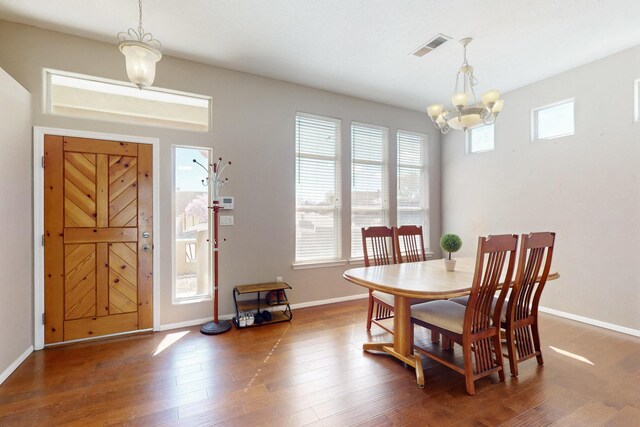 1001 Calle Garza NE, Albuquerque, NM 87113 - dining room featuring visible vents, wood finished floors, baseboards, and a chandelier