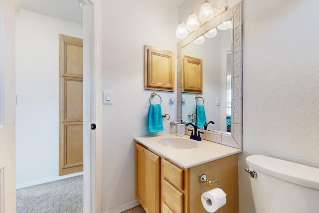 1001 Calle Garza NE, Albuquerque, NM 87113 - bathroom with baseboards, toilet, and vanity