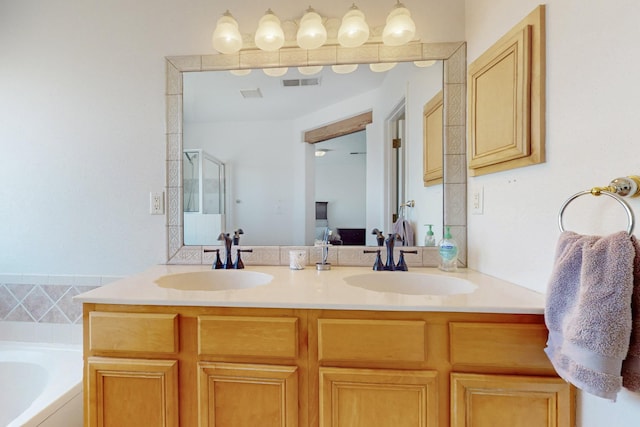 1001 Calle Garza NE, Albuquerque, NM 87113 - ensuite bathroom featuring double vanity, a bath, visible vents, and a sink