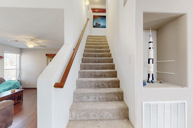 1001 Calle Garza NE, Albuquerque, NM 87113 - staircase featuring visible vents, wood finished floors, and a ceiling fan