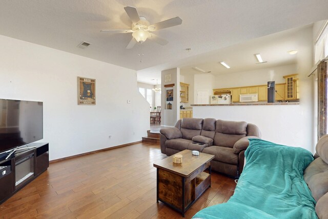 1001 Calle Garza NE, Albuquerque, NM 87113 - living area with visible vents, baseboards, ceiling fan, and wood finished floors