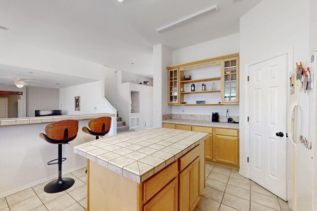 1001 Calle Garza NE, Albuquerque, NM 87113 - kitchen featuring light tile patterned flooring, tile countertops, and a center island