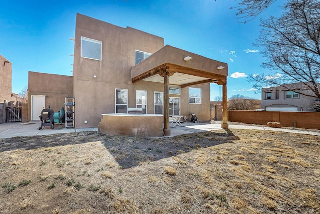 1001 Calle Garza NE, Albuquerque, NM 87113 - rear view of property featuring a gate, stucco siding, a patio, and fence