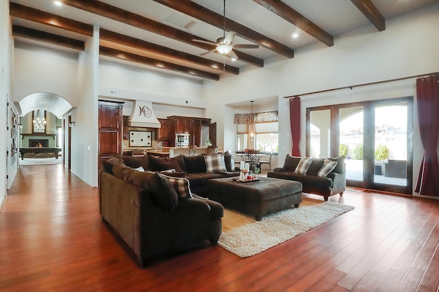 901 12th Ave SE, Rio Rancho, NM 87124 - living area with beam ceiling, ceiling fan, wood finished floors, a towering ceiling, and arched walkways