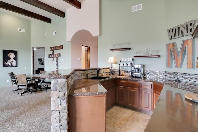901 12th Ave SE, Rio Rancho, NM 87124 - bar with a sink, a towering ceiling, beam ceiling, arched walkways, and light tile patterned floors