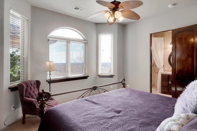 901 12th Ave SE, Rio Rancho, NM 87124 - carpeted bedroom with ensuite bathroom and a ceiling fan
