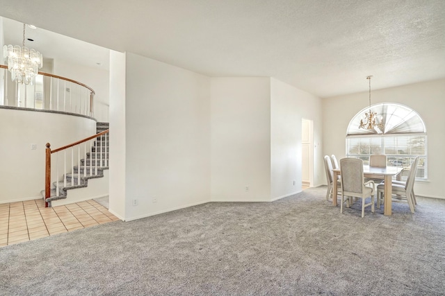 carpeted dining area featuring stairs, an inviting chandelier, tile patterned floors, and a textured ceiling