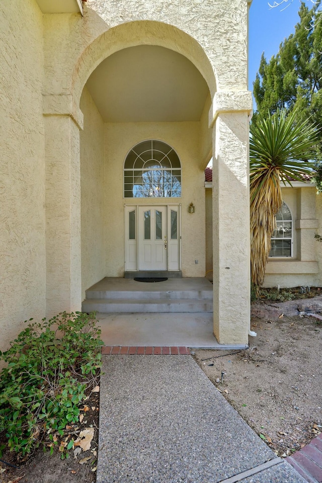 doorway to property with french doors and stucco siding