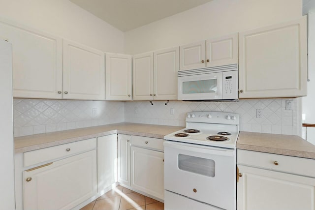 kitchen featuring white appliances, light tile patterned flooring, and light countertops