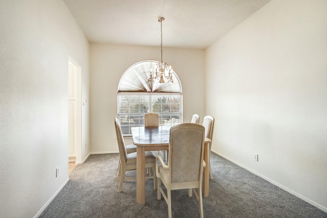 carpeted dining area featuring baseboards and a notable chandelier