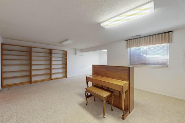 carpeted office space featuring visible vents and a textured ceiling