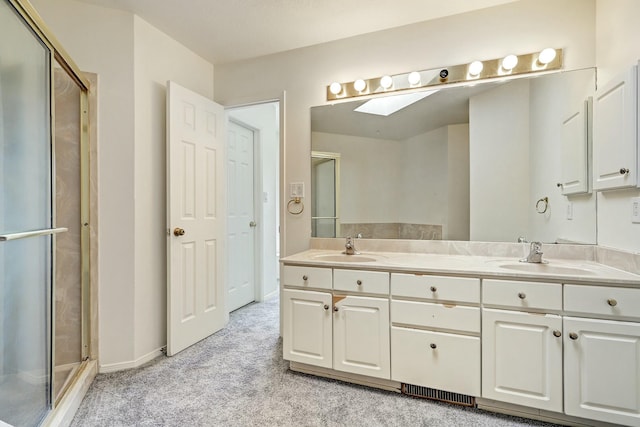 bathroom with a sink, carpet flooring, double vanity, and a shower stall