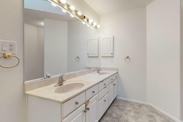 bathroom with a sink, baseboards, and double vanity