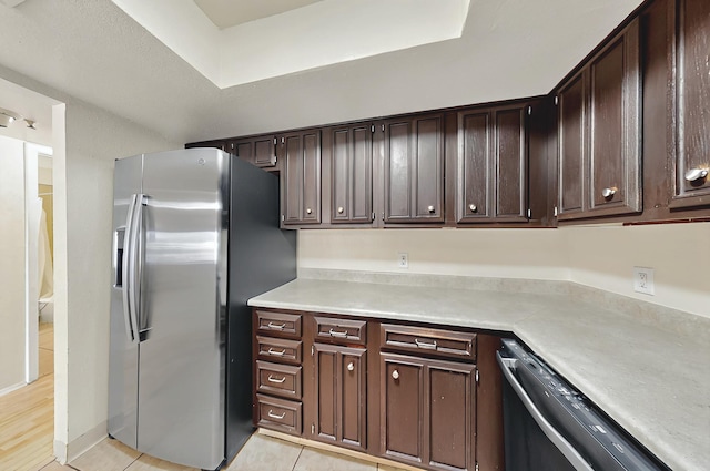 kitchen featuring dishwashing machine, dark brown cabinetry, stainless steel fridge with ice dispenser, and light countertops