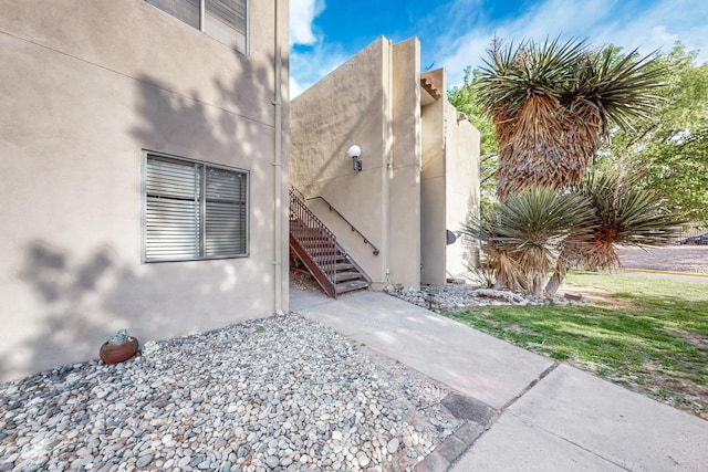 view of exterior entry featuring stucco siding