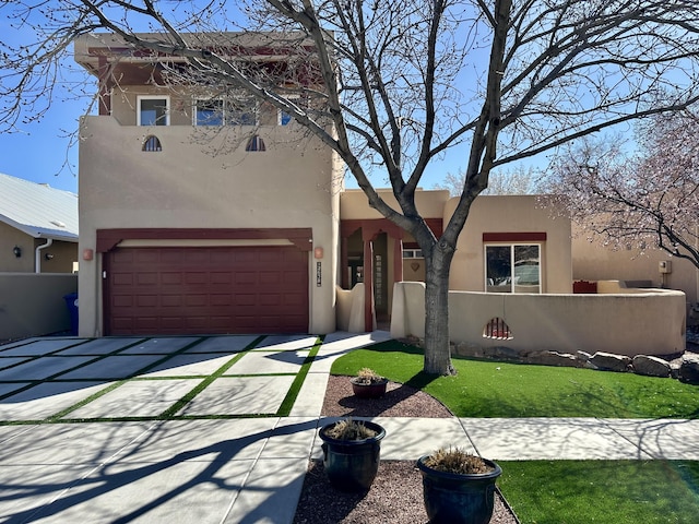 2638 Aloysia Ln NW, Albuquerque, NM 87104 - view of front of property with a front lawn, fence, concrete driveway, stucco siding, and a garage