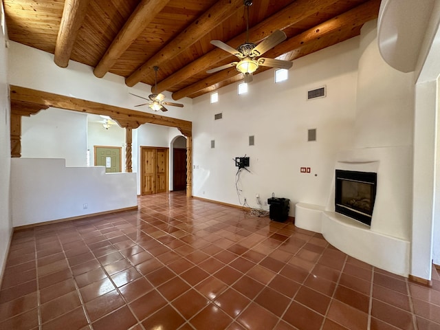 2638 Aloysia Ln NW, Albuquerque, NM 87104 - unfurnished living room featuring visible vents, wood ceiling, dark tile patterned floors, and a ceiling fan