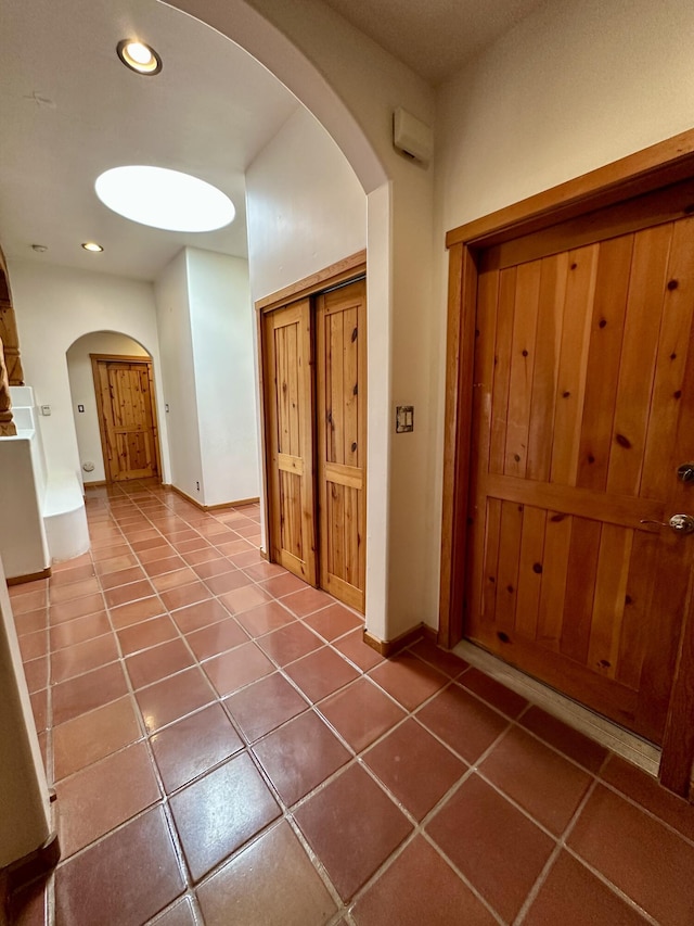 2638 Aloysia Ln NW, Albuquerque, NM 87104 - corridor with tile patterned flooring, recessed lighting, arched walkways, and baseboards