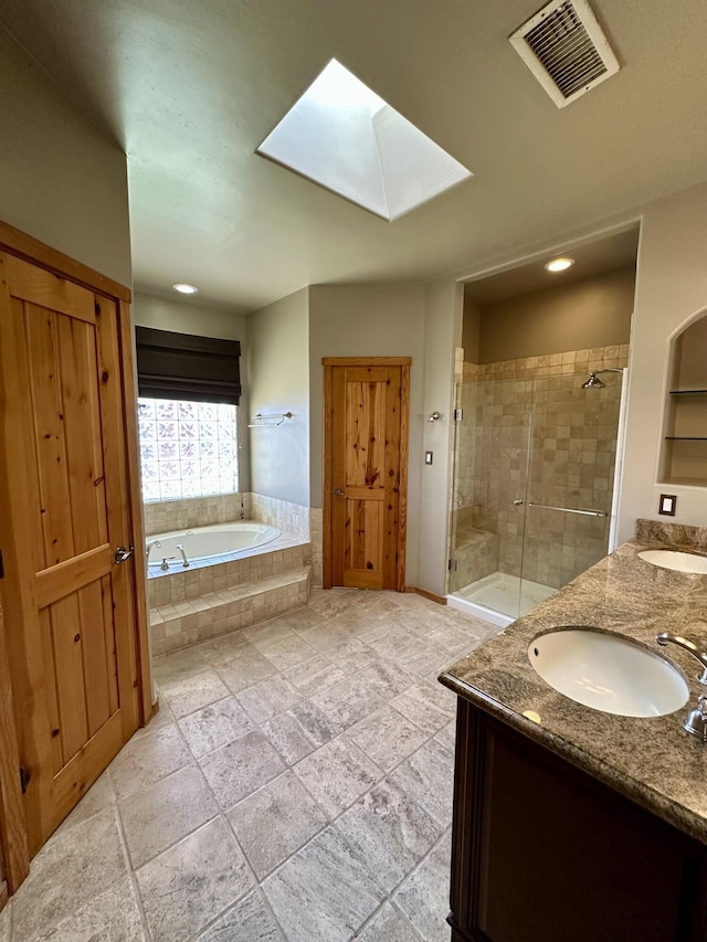 2638 Aloysia Ln NW, Albuquerque, NM 87104 - full bath featuring visible vents, a garden tub, a sink, a skylight, and a shower stall