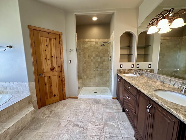 2638 Aloysia Ln NW, Albuquerque, NM 87104 - bathroom with double vanity, tiled tub, a stall shower, and a sink