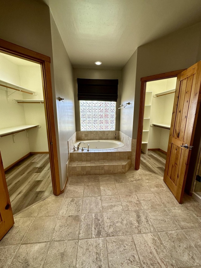 2638 Aloysia Ln NW, Albuquerque, NM 87104 - full bath with a walk in closet, a bath, and baseboards