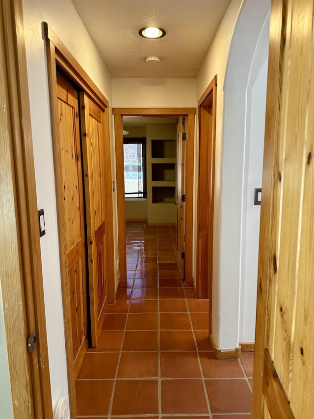 2638 Aloysia Ln NW, Albuquerque, NM 87104 - hall with arched walkways, a textured ceiling, and tile patterned flooring