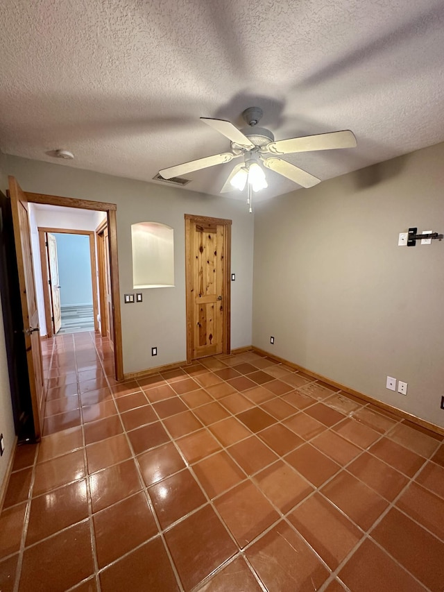 2638 Aloysia Ln NW, Albuquerque, NM 87104 - tiled empty room with a textured ceiling, a ceiling fan, visible vents, and baseboards