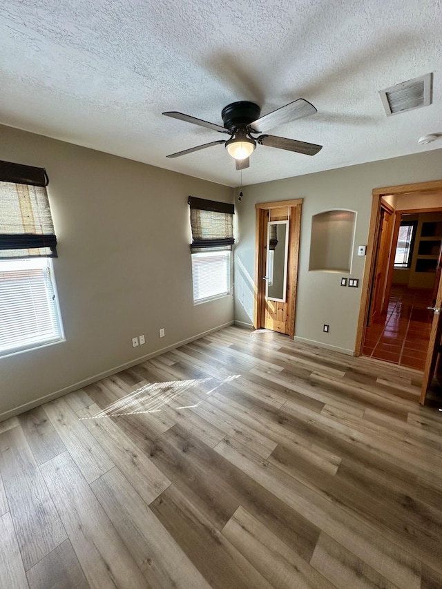 2638 Aloysia Ln NW, Albuquerque, NM 87104 - unfurnished room featuring ceiling fan, visible vents, baseboards, and wood finished floors